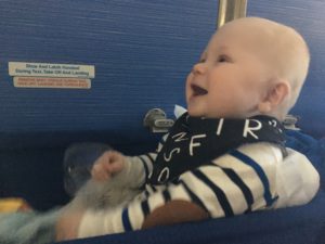 Blije baby in het vliegtuig